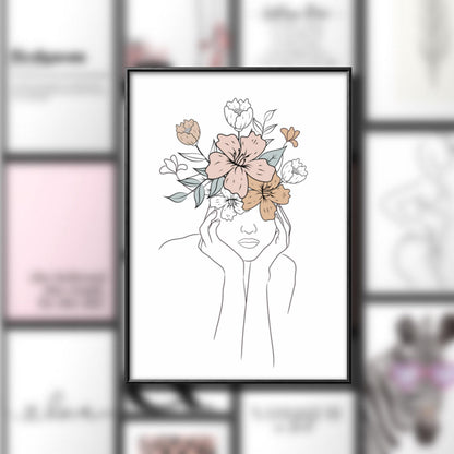 A black-framed line art print of a woman's head and shoulders with flowers instead of hair, in focus against a blurred background of other prints.